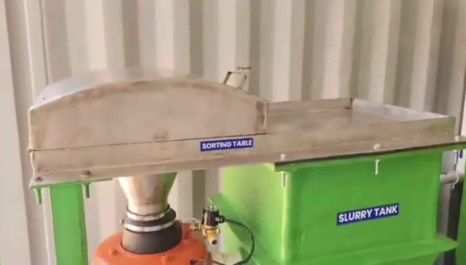 Stainless sorting table above the slurry tank
